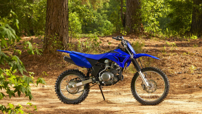 Yamaha TT-R125 parkirana na gozdni jasi – celoten bočni pogled